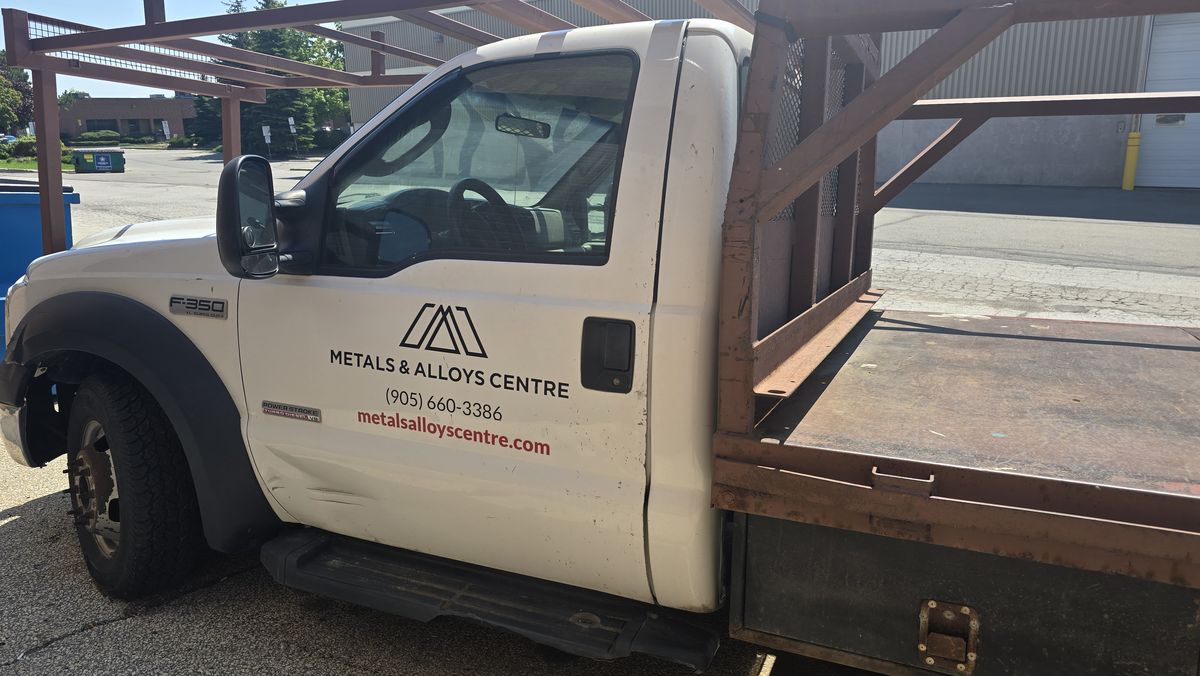Metals & Alloys Centre branded F-350 flatbed delivery truck